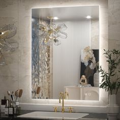 a bathroom with a sink, mirror and gold faucet in front of it