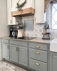 an instagram photo of a kitchen with white cabinets and gold handles