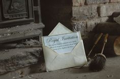 an envelope and rat on the ground next to a fire place