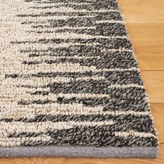 a close up of a rug on a wooden floor with wood floors in the background