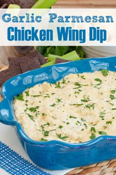 a blue casserole dish filled with chicken wing dip