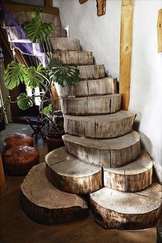 a bunch of logs stacked on top of each other in front of a planter