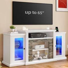 a white entertainment center with an up to 65 sign above it