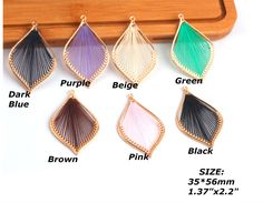 four different colors of earrings on a wooden hanger, with the description below it