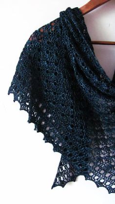 a black shawl on a wooden hanger