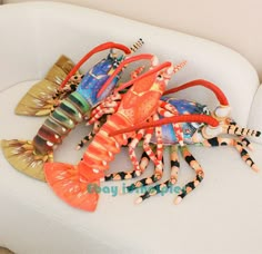 a group of lobsters sitting on top of a white couch next to each other