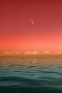 an orange and red sky over the ocean with clouds in the foreground, and a distant object in the distance