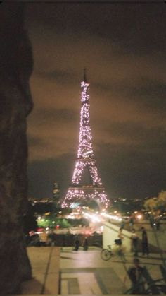 the eiffel tower is lit up at night