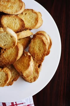 toasted bread on a white plate with a red and white checkered napkin