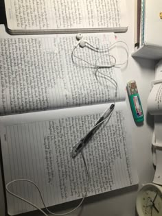 an open book sitting on top of a table next to a pair of headphones