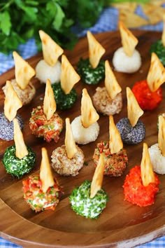 small appetizers are arranged on a wooden plate