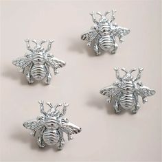 three silver bees sitting on top of each other