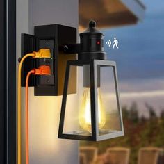 a light that is on the side of a wall next to a window with an orange cord