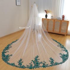 a wedding veil with blue flowers on it