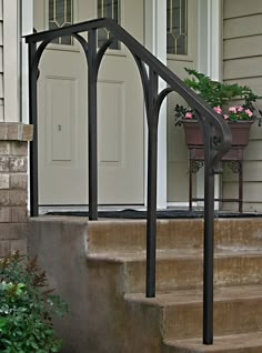 an iron railing on the front steps of a house