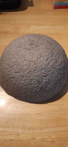 a large rock sitting on top of a wooden floor