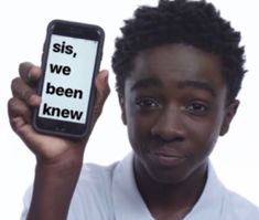 a young man holding up a cell phone with the words sis, we been knew on it