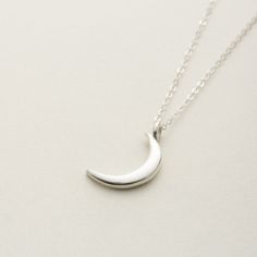 The necklace with the image of a delicate new moon is You can wear it simply and without hesitation.  The moon motif of thes necklace is somewhat mysterious and gentle. Matching earrings are also available. Anyway, I recommend this jewelry as a cute and versatile bracelet! "Sterling Silver" Sterling silver(sv925)  Made in Japan.  Care Guide To make your delicate jewelry last for a long time, please follow these guidelines: Avoid putting on or taking off clothes while wearing jewelry, as it can c Delicate Crescent Moon Phase Jewelry, Elegant Moon-shaped Sterling Silver Jewelry, Dainty Crescent White Gold Jewelry, Minimalist Jewelry With Moon Charm, Celestial Moon Shaped Sterling Silver Necklace, Sterling Silver Moon Necklace In Celestial Style, Sterling Silver Charm Necklace With Moon Phase Pendant, Sterling Silver Moon Phase Charm Necklace, Celestial Moon-shaped Sterling Silver Necklace