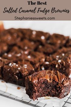 the best salted caramel fudge brownies on a cooling rack with one piece cut out