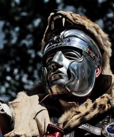 a man wearing a silver mask and fur coat