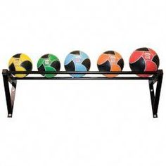 four different colored balls are on a black rack with metal legs and two rows of them