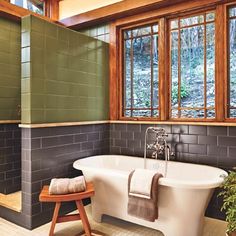 a bathroom with a claw foot tub and wooden windows