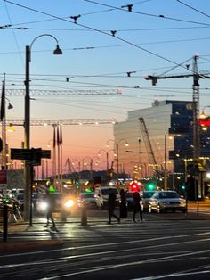 many cars are driving down the street at dusk