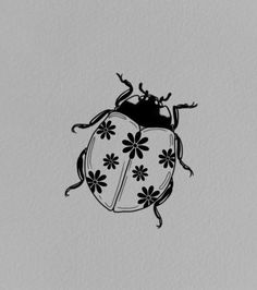 a black and white drawing of a lady bug with flowers on it's back