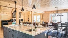 a kitchen with an island and wooden walls