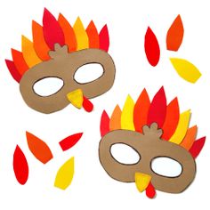 two paper masks with fire and leaves on them, one has a red nose and the other is a brown mask