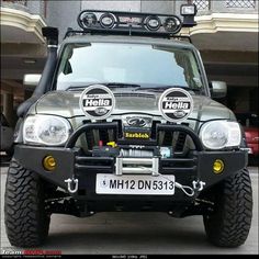 the front view of a vehicle with lights on it's headlamps and four wheel drive tires