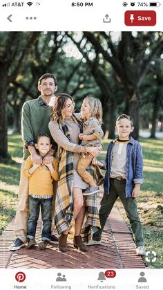 a family posing for a photo in the park