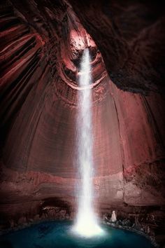 a large waterfall cascading into a pool of water