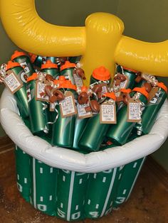 a basket filled with lots of green and orange items