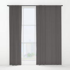 an open window with grey curtains and white walls