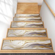 a set of stairs that have been painted with gold and silver paint on the treads