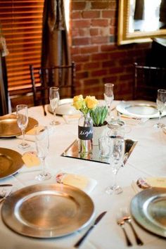 the table is set with plates and silverware