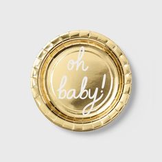 a gold foil plate with the words oh baby printed in white on it's side