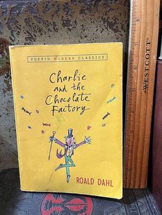 a yellow book with the title charlie and the chocolate factory written on it