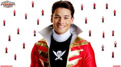 a man in a red and gold jacket is smiling