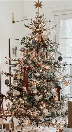 a decorated christmas tree with presents under it