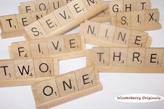 several scrabble tiles with words that spell out the word five, seven and nine