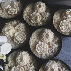 there are many cupcakes with white flowers on them