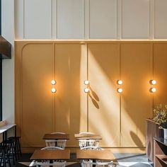 the interior of a restaurant with wooden tables and chairs