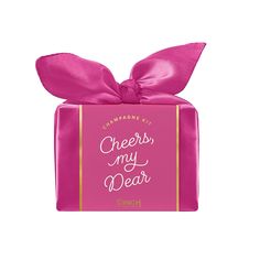 a pink gift box with a bow on top that says cheers, my dear in gold lettering