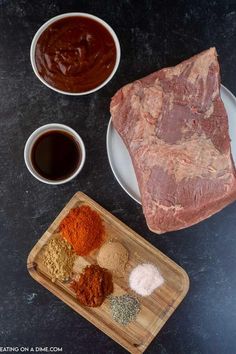 steak, spices and seasonings on a cutting board next to a bowl of sauce