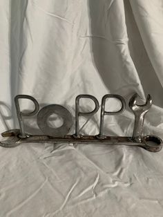 a metal sign that says pop on it