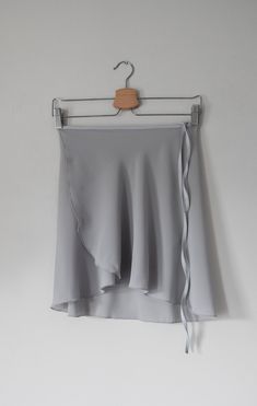 Ready for ballet class? Our classic, light grey -colored wrap ballet skirt is exactly made for that! This ballet dress is handmade with a stretchy light grey nylon waist tie for a comfortable experience. Crafted 100% out of polyester chiffon with a right above the knee design for a vintage look. ✷ Perfect for Recital ✷ This light grey ballet dress is the perfect choice for a vintage/classy-style recital. A conservative style with a right above the knee design for a formal performance. Not only t Ballet Fits, Light Grey Skirt, Conservative Style, Short Wrap Skirt, Long Wrap Skirt, Fabric Steamer, Conservative Fashion, Ballet Clothes, Grey Skirt