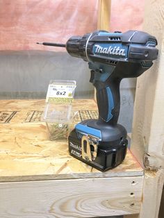 a cordless driller sitting on top of a wooden table