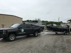 a truck towing a boat on the back of it